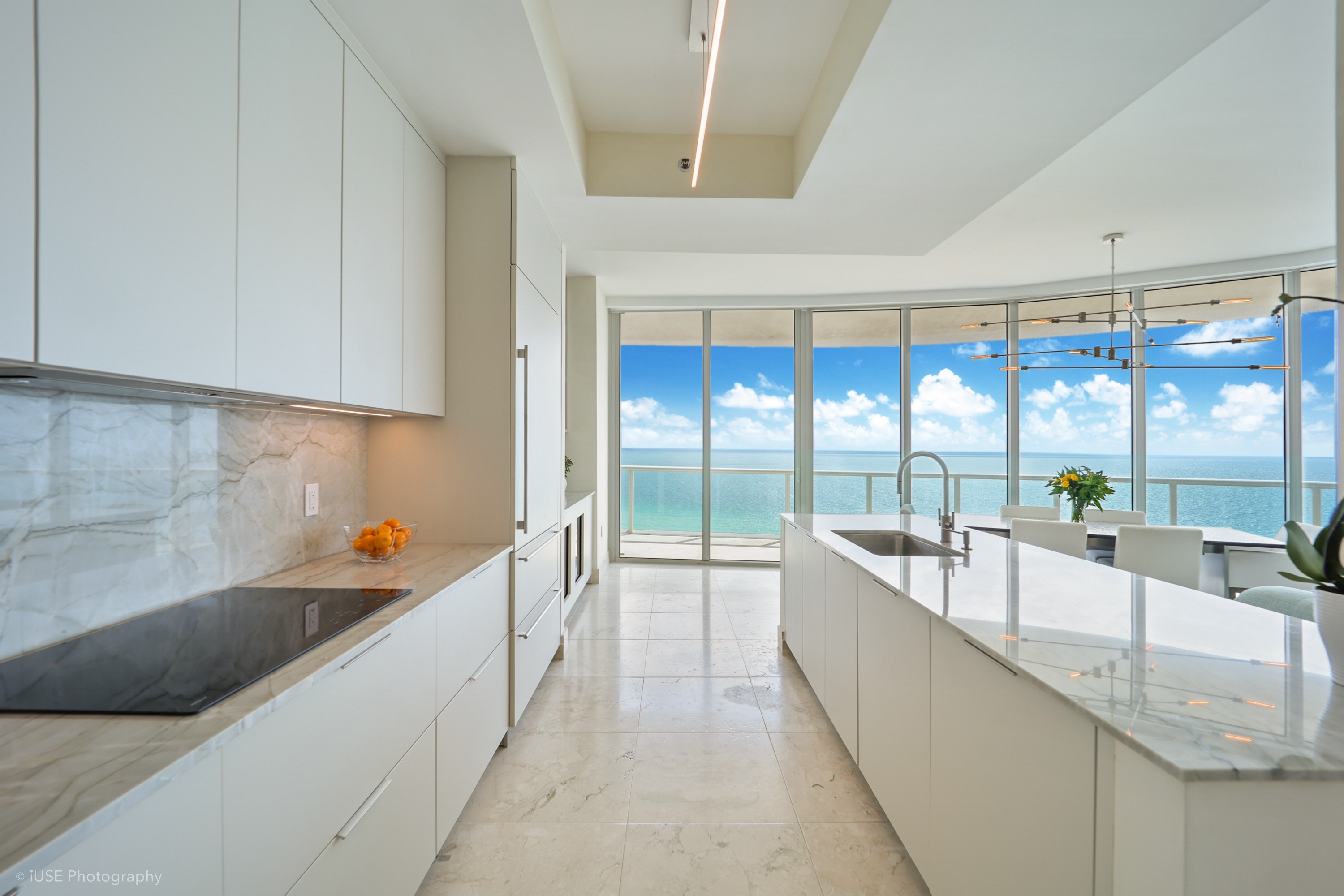 Oceanfront kitchen with marble countertops and floor-to-ceiling ocean views